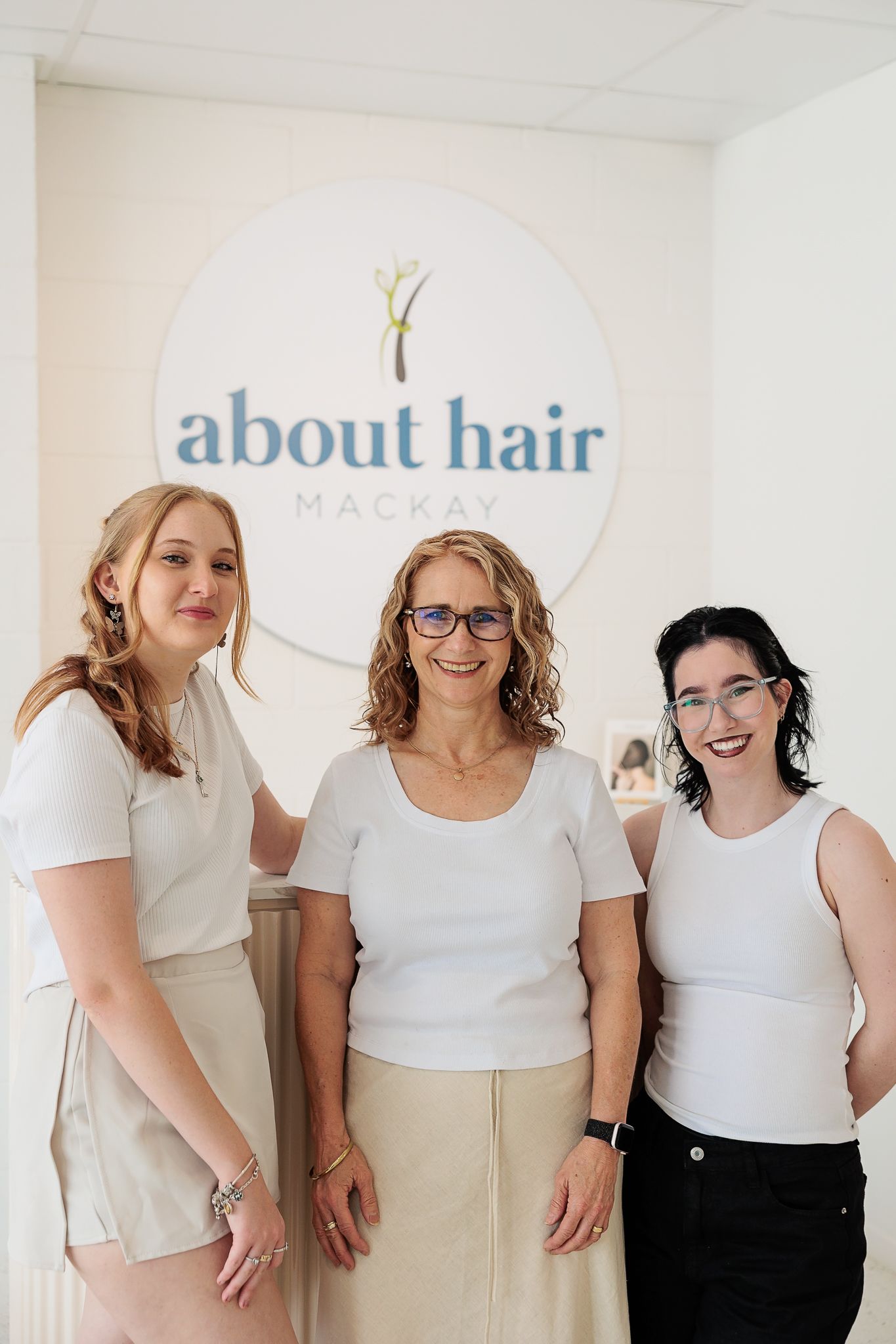 About Hair Mackay stylists styling a client's hair together in the salon