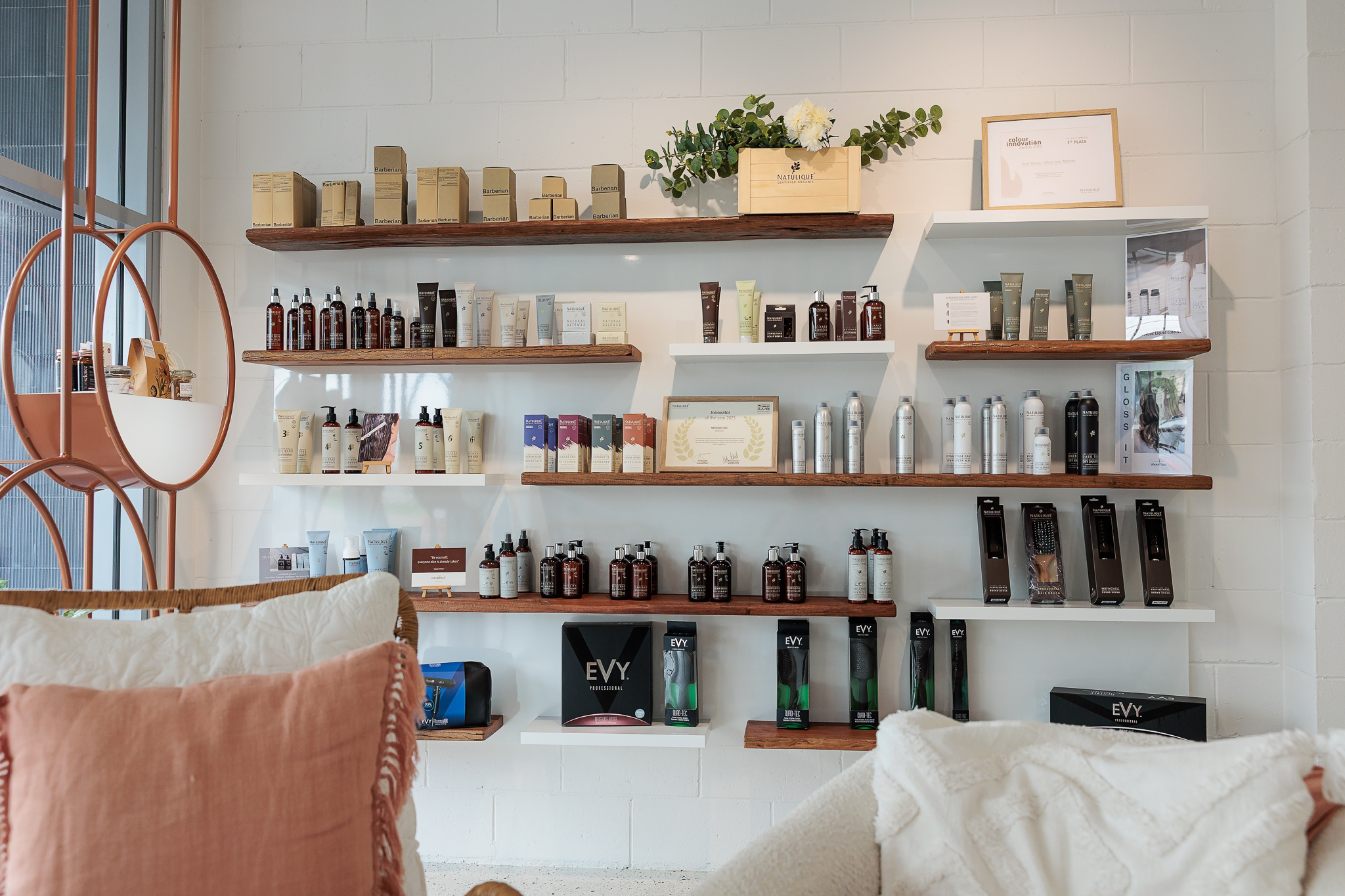 About Hair Mackay organic product shelf featuring NATULIQUE products